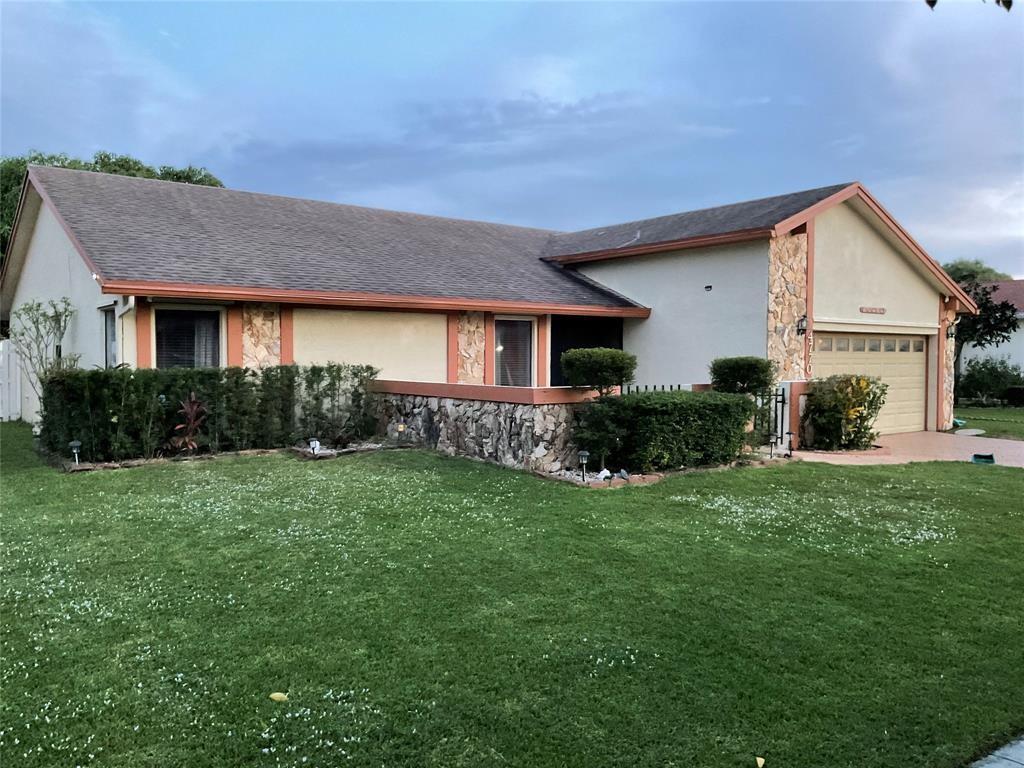 4770 Northwest 85th Avenue Lauderhill, FL 33351 - Photo 3 of 44 a front view of a house with a yard and plants
