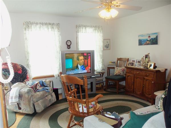45 Beach Fall River Ma Fall River, MA 02721 - Photo 5 of 18 a living room with furniture a couch and a chandelier