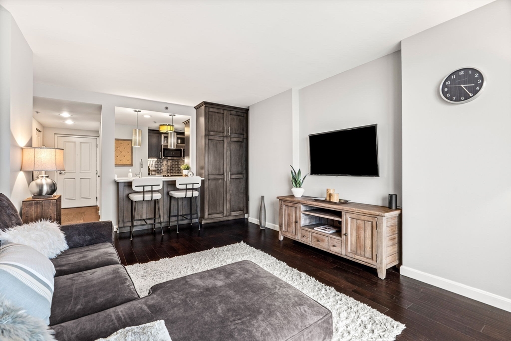 10 Museum Way, Unit 828 Cambridge, MA 02141 - Photo 1 of 36 a living room with furniture and a flat screen tv