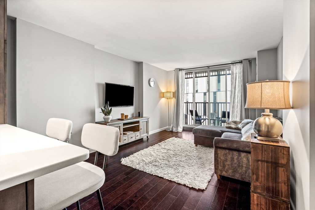 10 Museum Way, Unit 828 Cambridge, MA 02141 - Photo 11 of 36 a living room with furniture and a flat screen tv