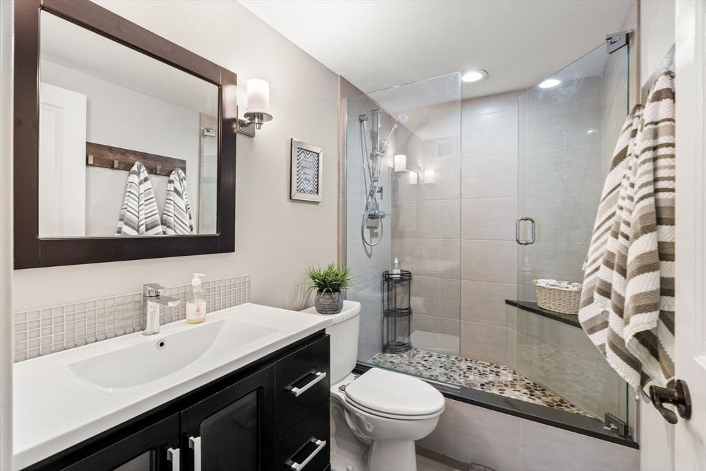 10 Museum Way, Unit 828 Cambridge, MA 02141 - Photo 16 of 36 a bathroom with a sink a toilet a shower and a mirror