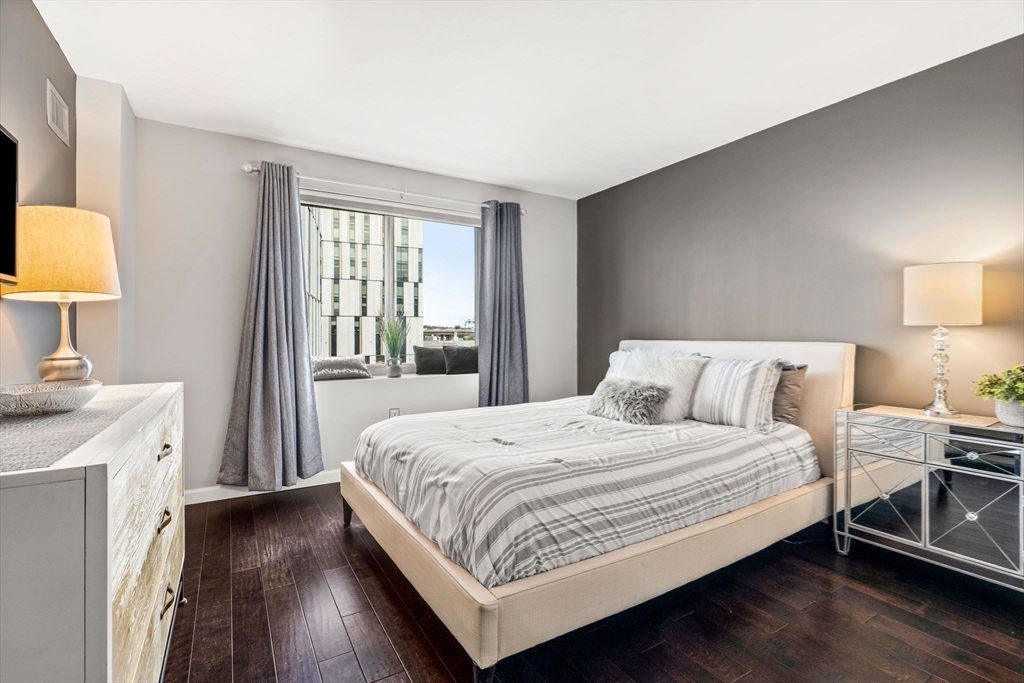 10 Museum Way, Unit 828 Cambridge, MA 02141 - Photo 18 of 36 a bedroom with a bed and a lamp on the dresser
