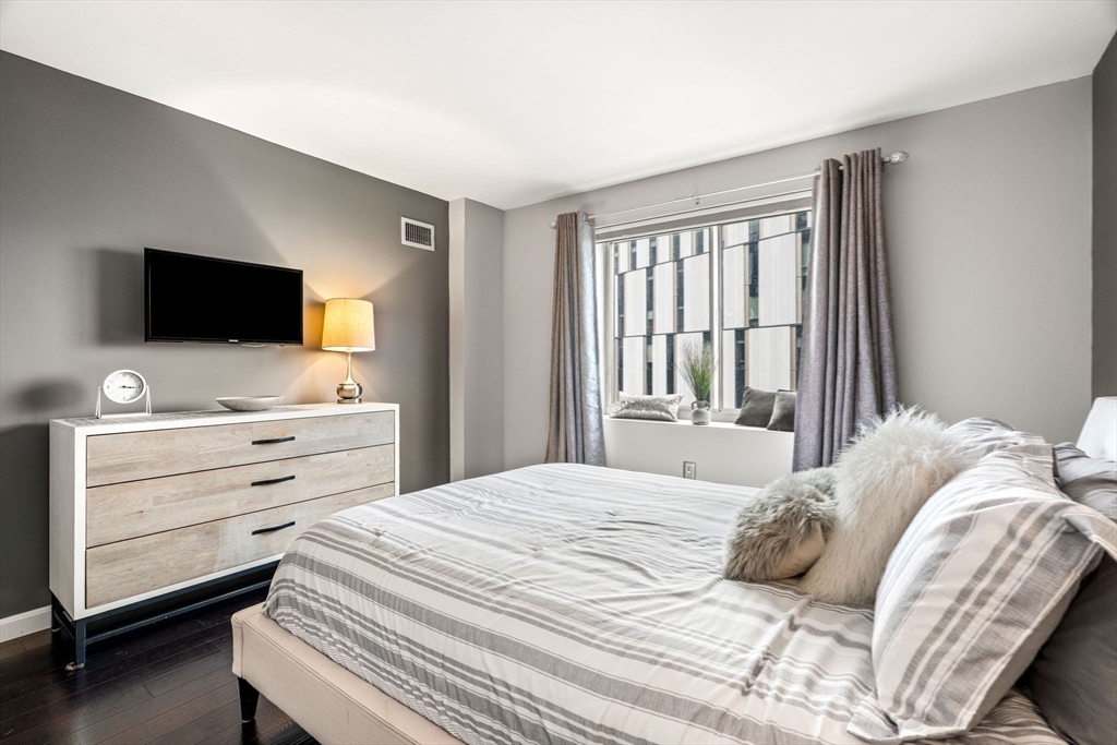 10 Museum Way, Unit 828 Cambridge, MA 02141 - Photo 19 of 36 a bedroom with a bed and a flat screen tv