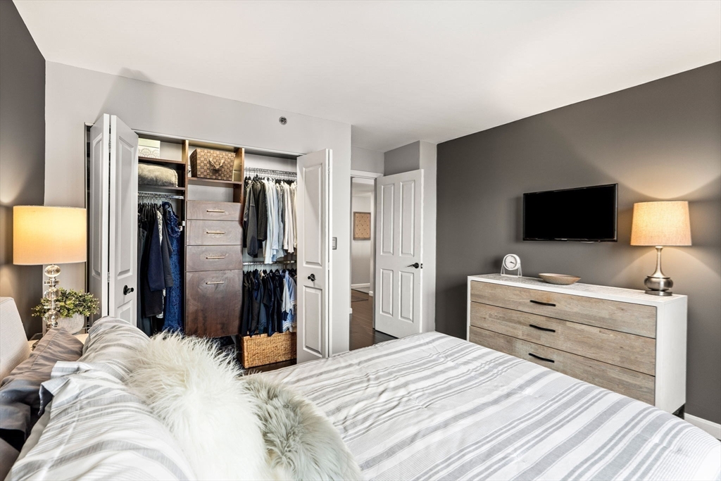 10 Museum Way, Unit 828 Cambridge, MA 02141 - Photo 21 of 36 a bedroom with a bed and a flat screen tv