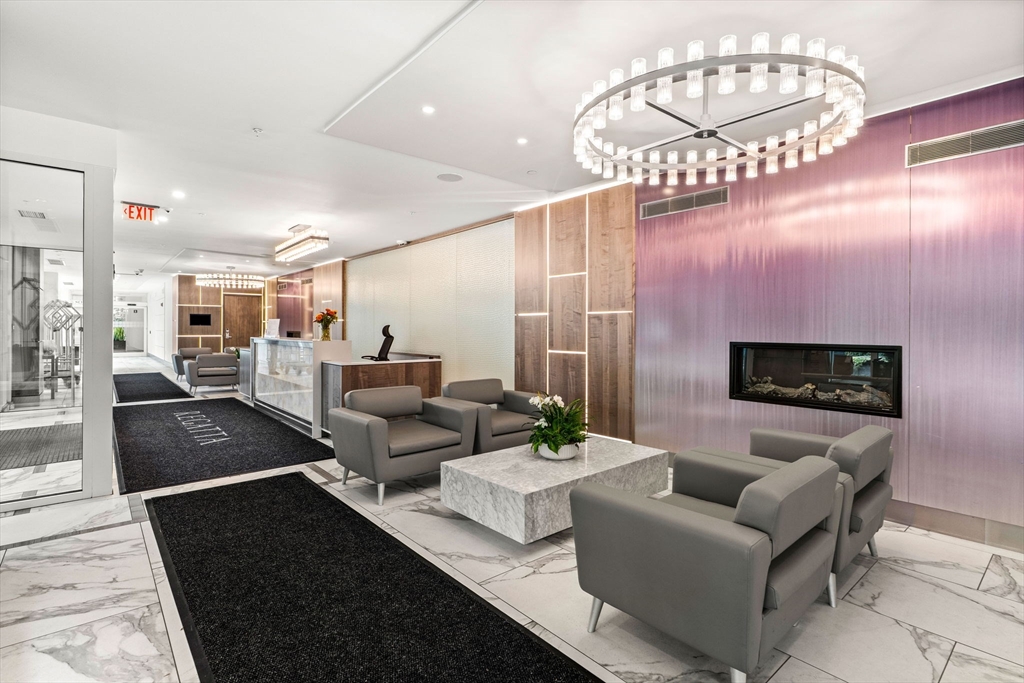 10 Museum Way, Unit 828 Cambridge, MA 02141 - Photo 30 of 36 a living room with furniture and a chandelier