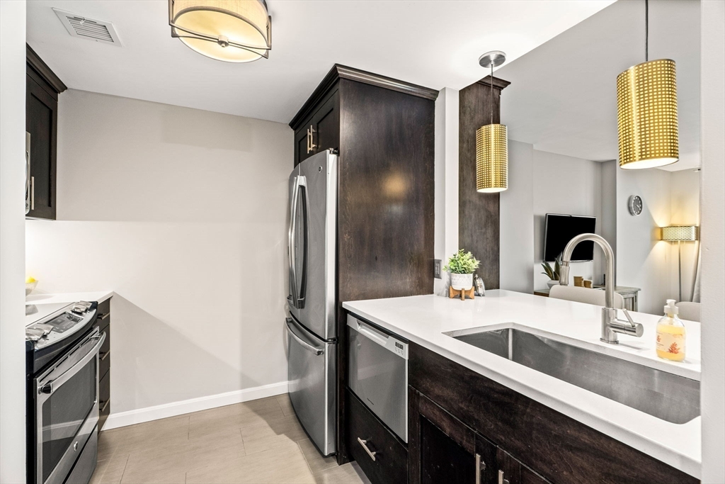 10 Museum Way, Unit 828 Cambridge, MA 02141 - Photo 6 of 36 a kitchen with a sink and refrigerator