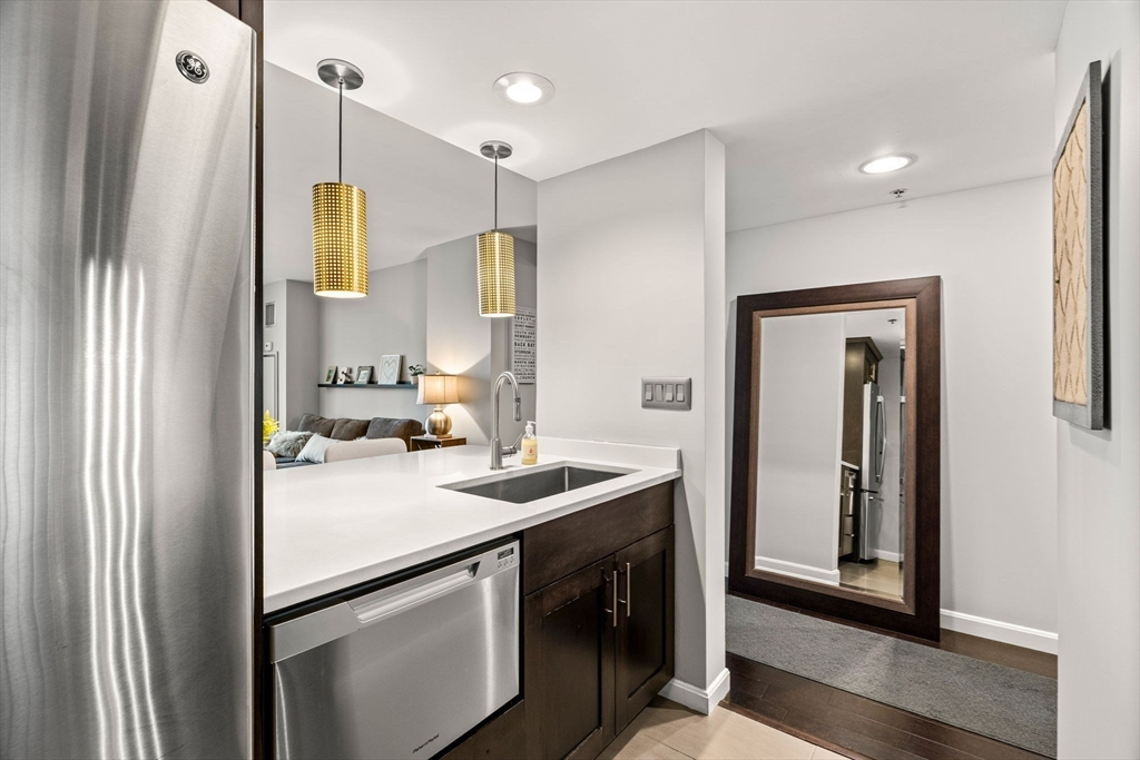 10 Museum Way, Unit 828 Cambridge, MA 02141 - Photo 7 of 36 a kitchen with a sink a refrigerator and a stove