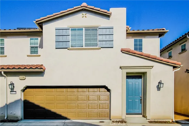 a view of a house with wooden fence