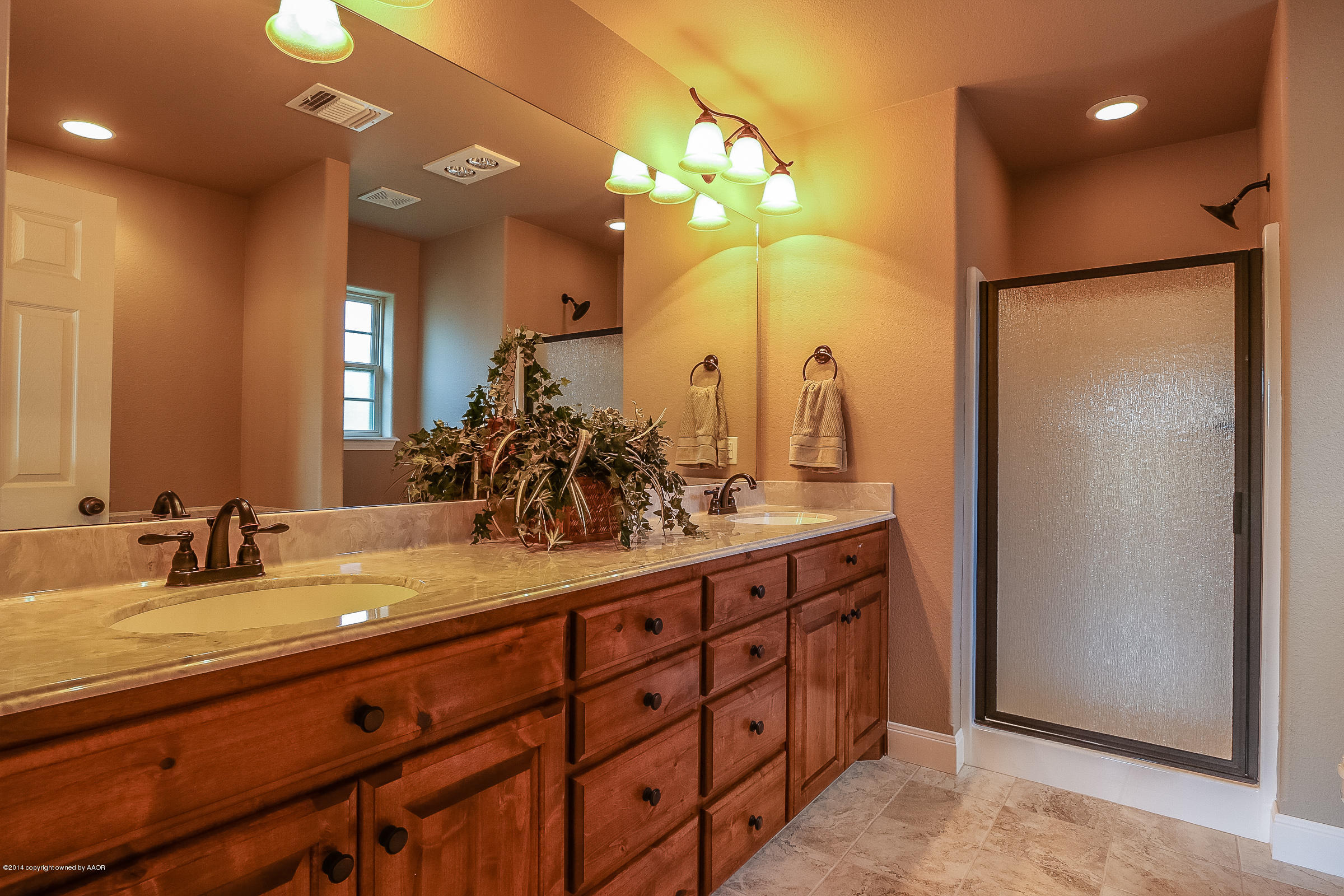 3906 Arden Road Amarillo, TX 79118 - Photo 13 of 22 a bathroom with a double vanity sink and a mirror