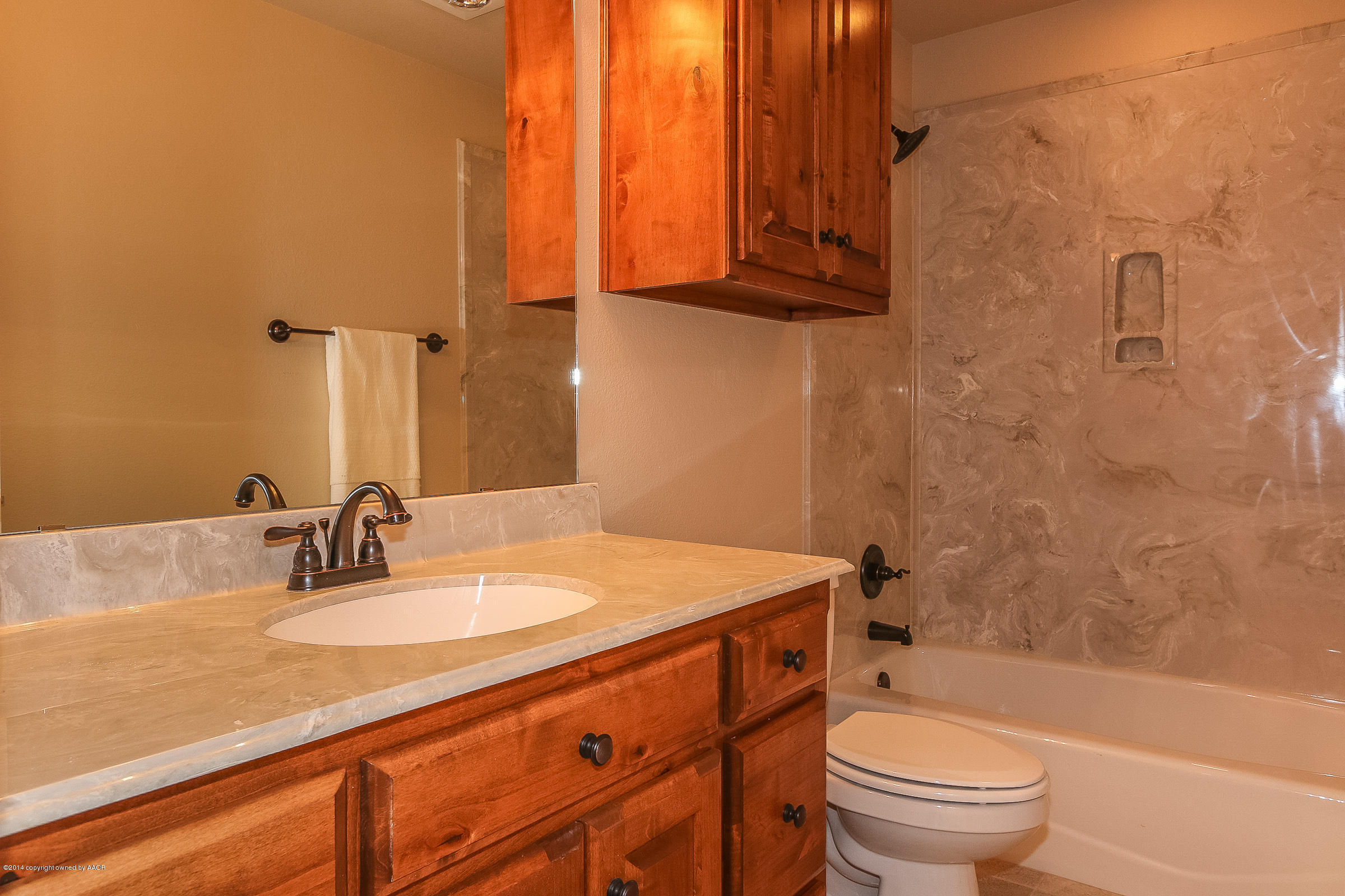 3906 Arden Road Amarillo, TX 79118 - Photo 17 of 22 a bathroom with a granite countertop sink toilet and shower