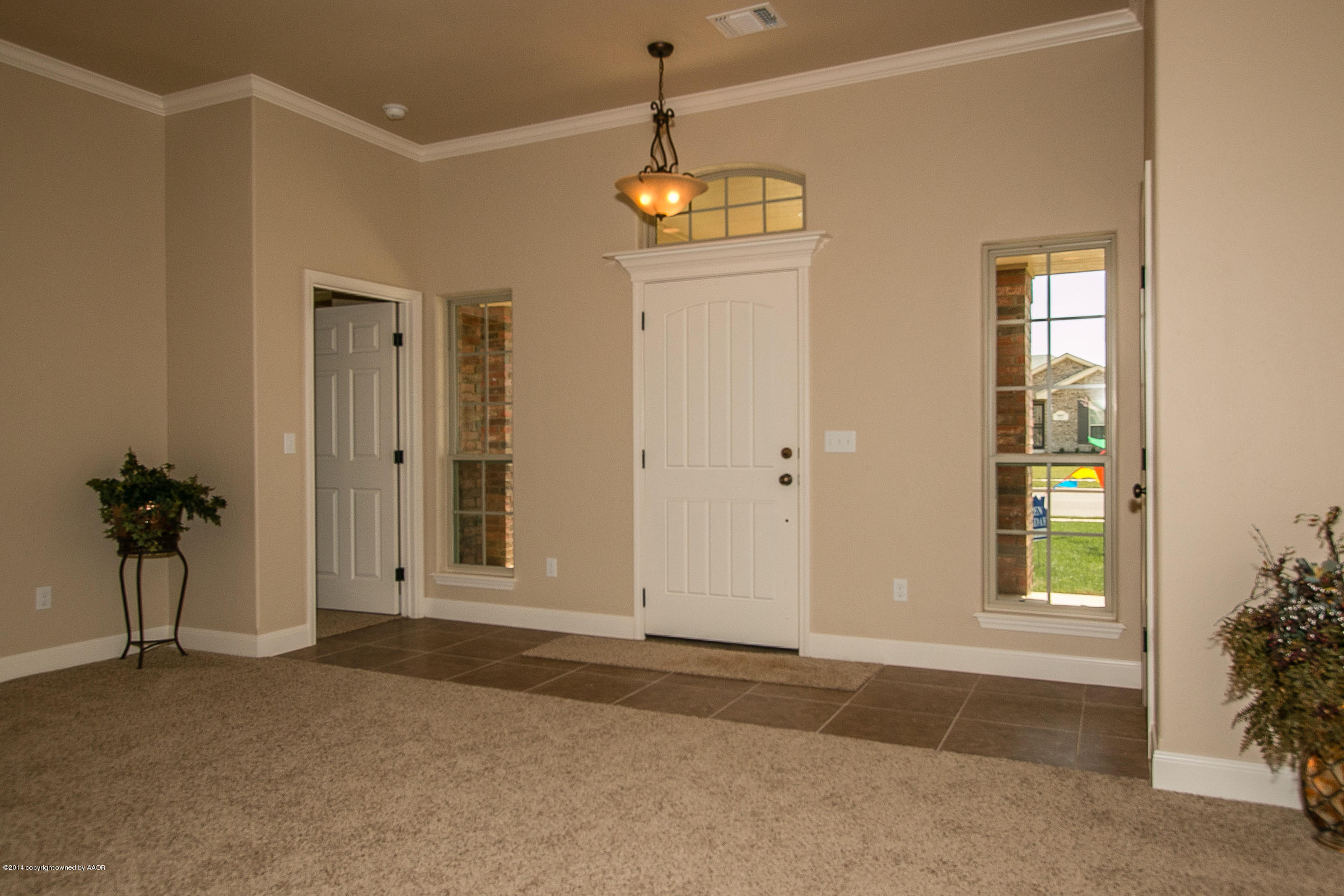 3906 Arden Road Amarillo, TX 79118 - Photo 3 of 22 a view of a hallway with a chandelier