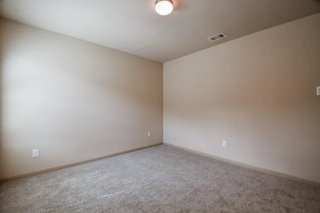 an empty room with windows and closet