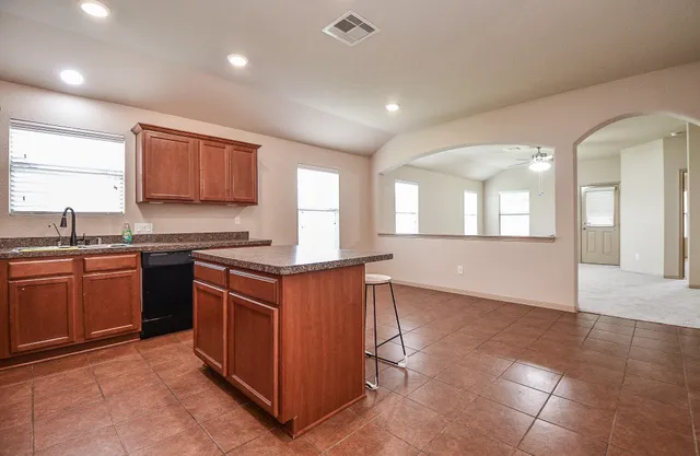 a view of a kitchen with furniture and appliances