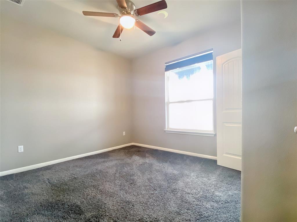 8901 Panhandle Drive Austin, TX 78747 - Photo 16 of 21 Room with neutral wall paint and gray carpeting