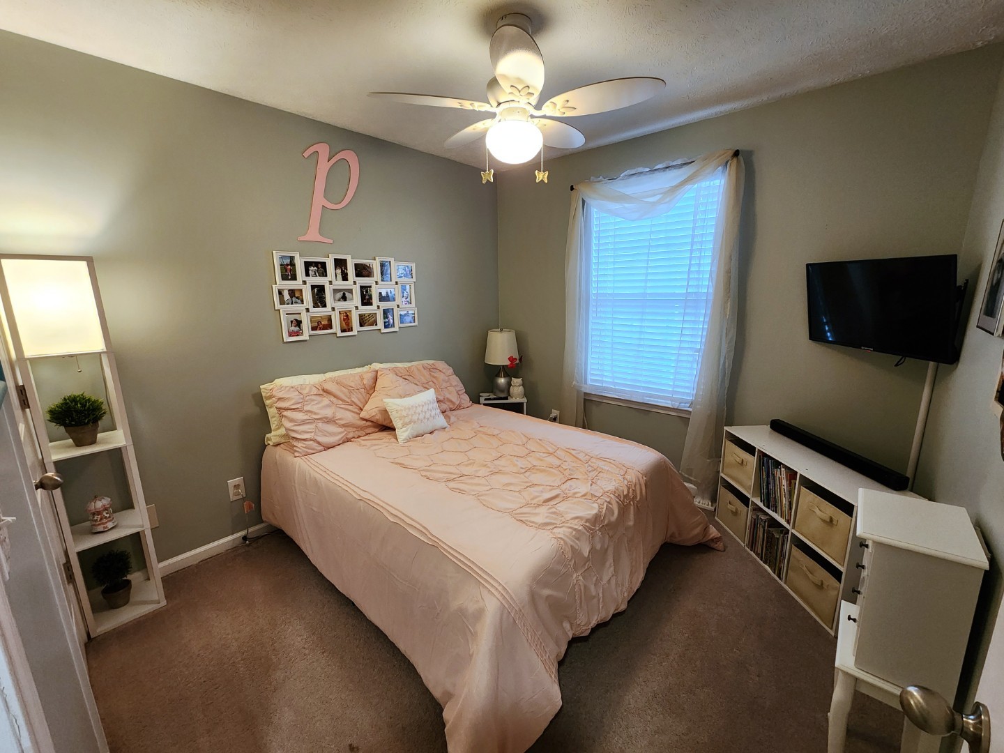 1049 Woodall Road Lebanon, TN 37090 - Photo 28 of 41 a bedroom with a bed a flat screen tv and a ceiling fan