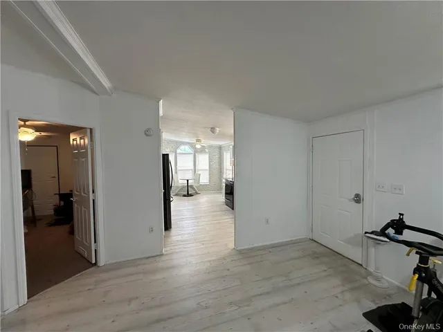 a view of a room with wooden floor