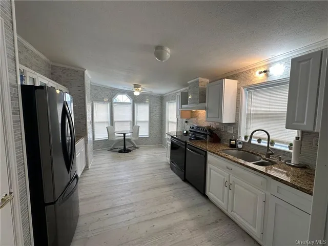 a kitchen with refrigerator and cabinets