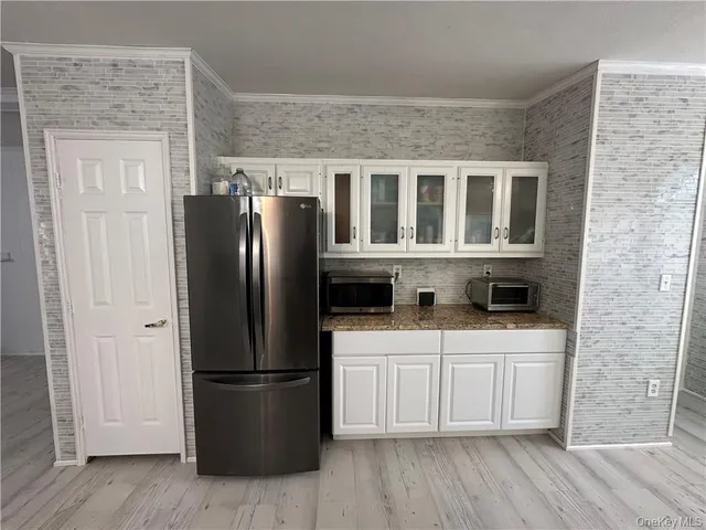 a kitchen with stainless steel appliances a refrigerator sink and cabinets