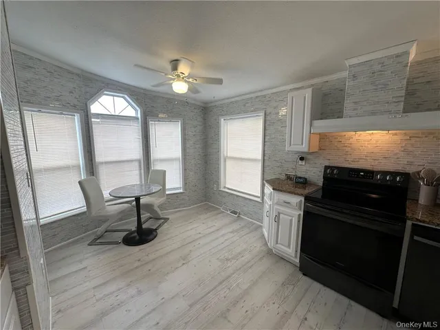 a kitchen with granite countertop a stove a sink and a refrigerator