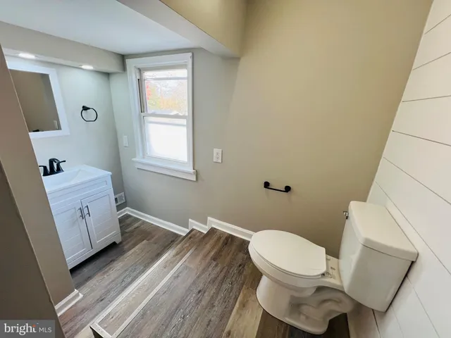 a bathroom with a sink toilet and window