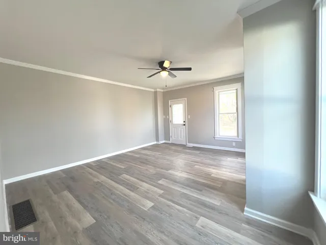 wooden floor in an empty room with a window