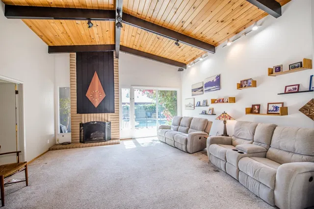 a kitchen with stainless steel appliances granite countertop a stove a sink and white cabinets with wooden floor