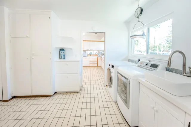 a dining room with furniture and a floor to ceiling window