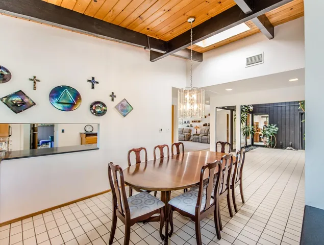 a dining room with furniture and wooden floor