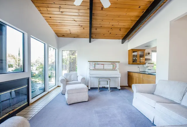 a living room with a bed next to a window
