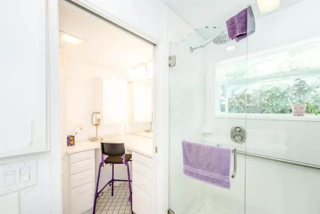 a bathroom with a double vanity sink and a large mirror