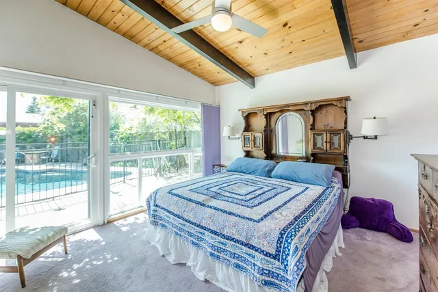 a living room with furniture a floor to ceiling window and a floor to ceiling window
