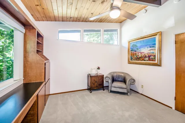a view of a balcony with chairs and a potted plant