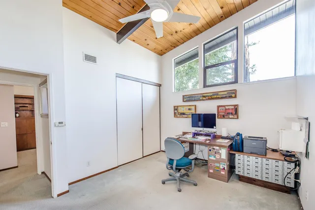 a view of a house with backyard sitting area and swimming pool