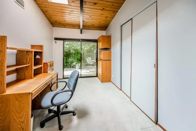 a view of a porch with furniture and floor to ceiling window