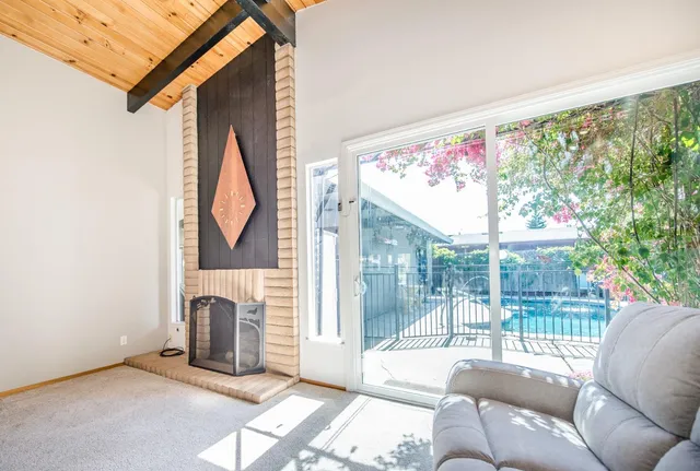 a backyard of a house with lots of green space and fountain