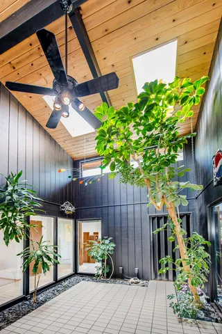 a view of a chairs and table in the balcony
