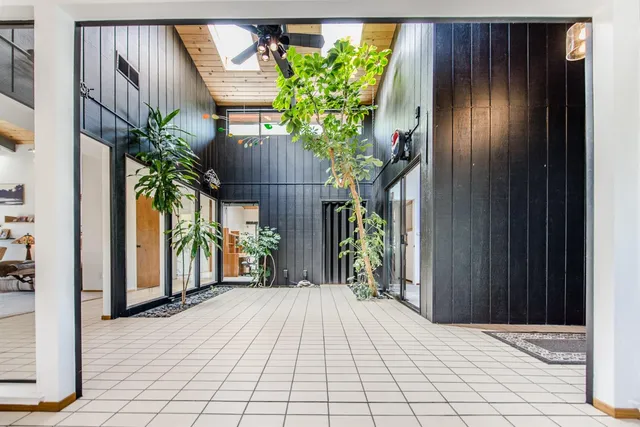 a living room with furniture a fireplace and a window