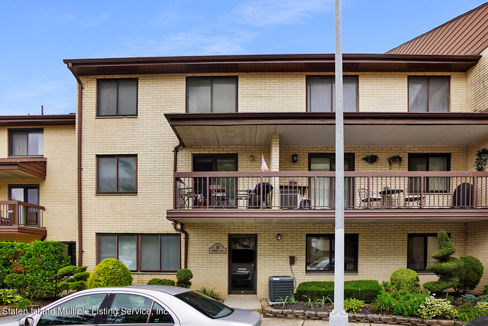 10 Windham Loop, Unit 1A Staten Island, NY 10314 - Photo 1 of 19 a front view of a house with balcony