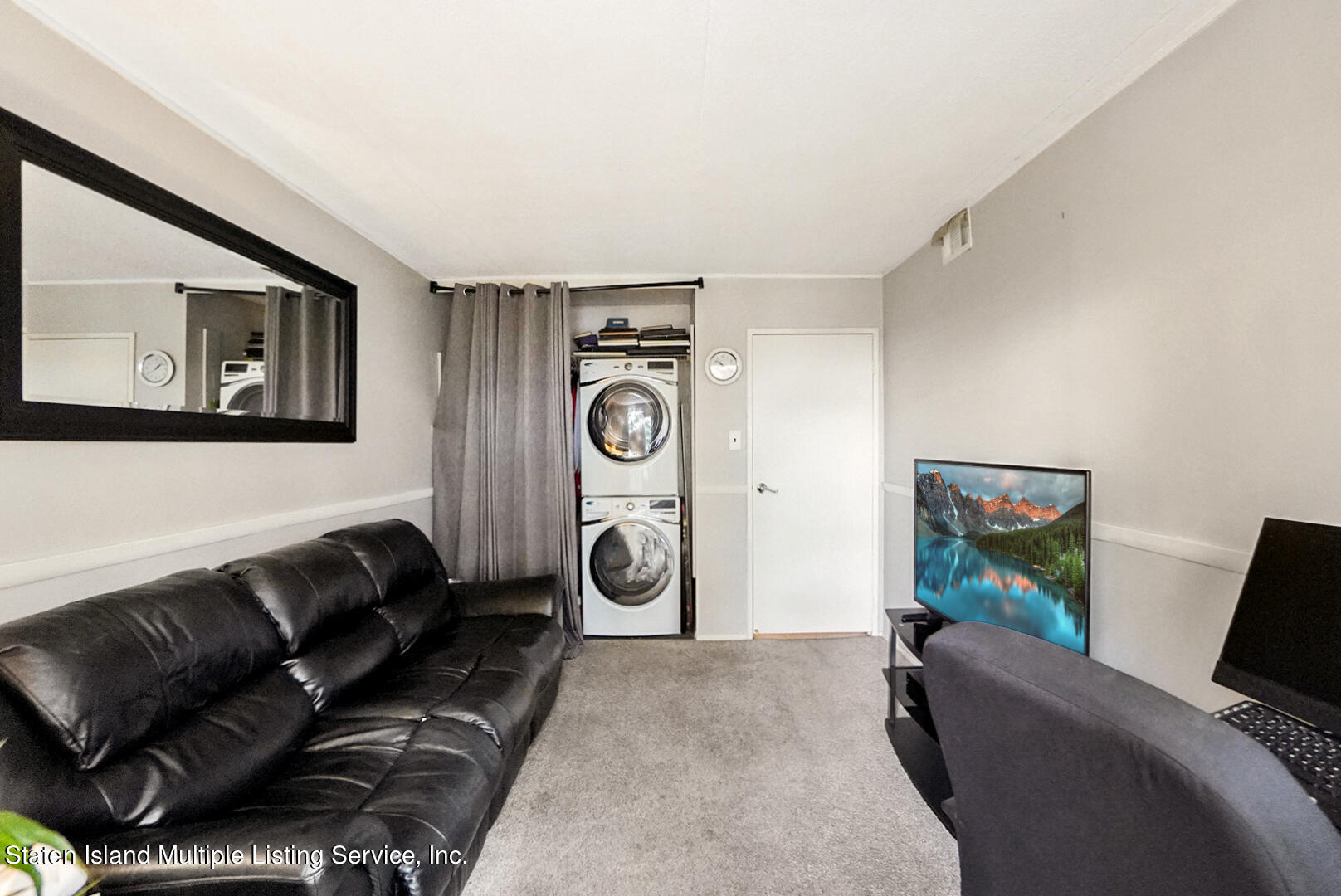 10 Windham Loop, Unit 1A Staten Island, NY 10314 - Photo 12 of 19 a living room with furniture and a flat screen tv