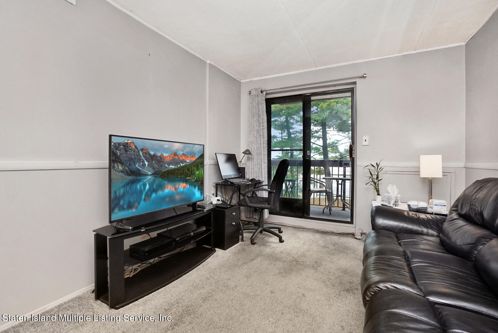 10 Windham Loop, Unit 1A Staten Island, NY 10314 - Photo 13 of 19 a living room with furniture and a flat screen tv