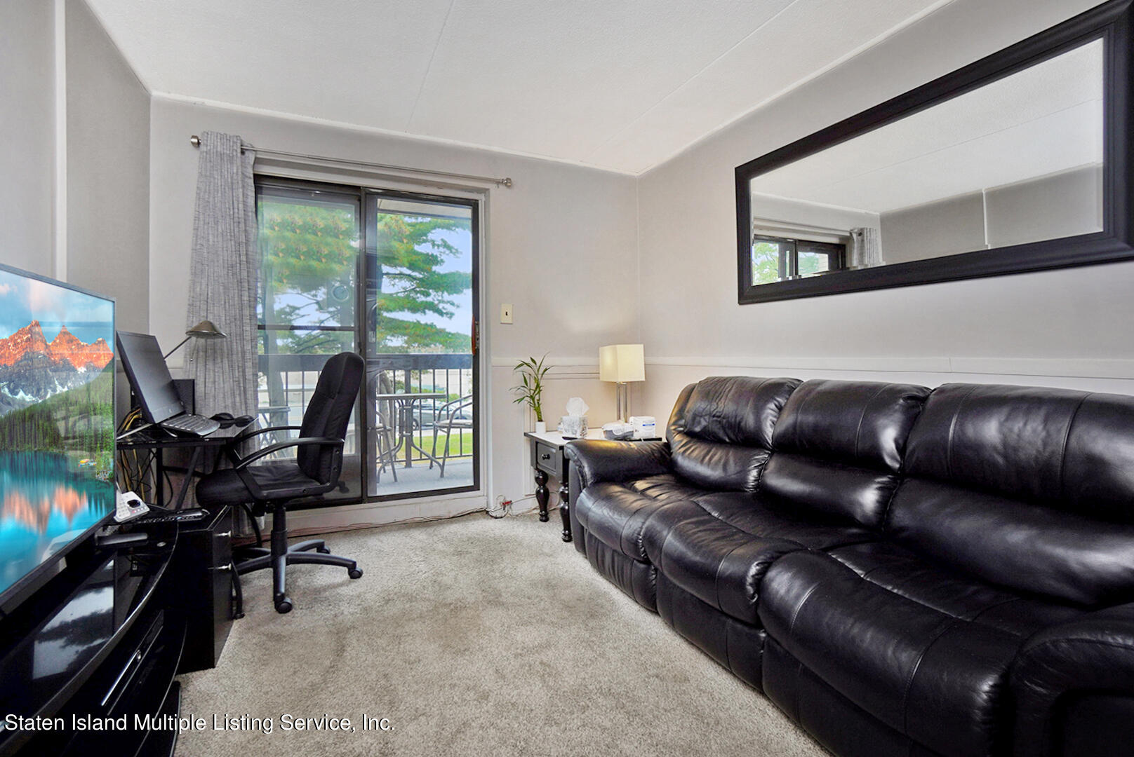 10 Windham Loop, Unit 1A Staten Island, NY 10314 - Photo 14 of 19 a living room with furniture and a flat screen tv