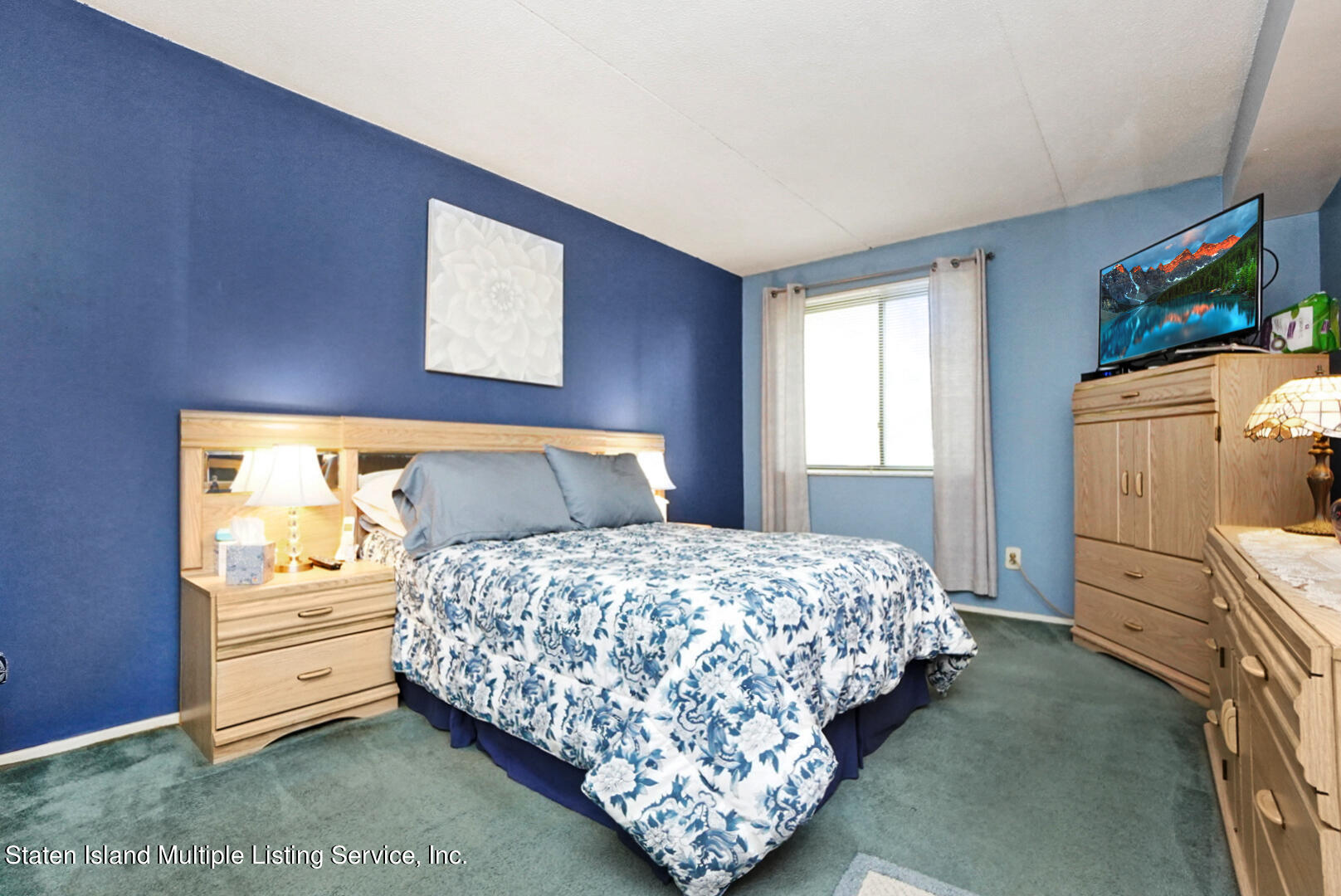 10 Windham Loop, Unit 1A Staten Island, NY 10314 - Photo 15 of 19 a bedroom with a bed and a window