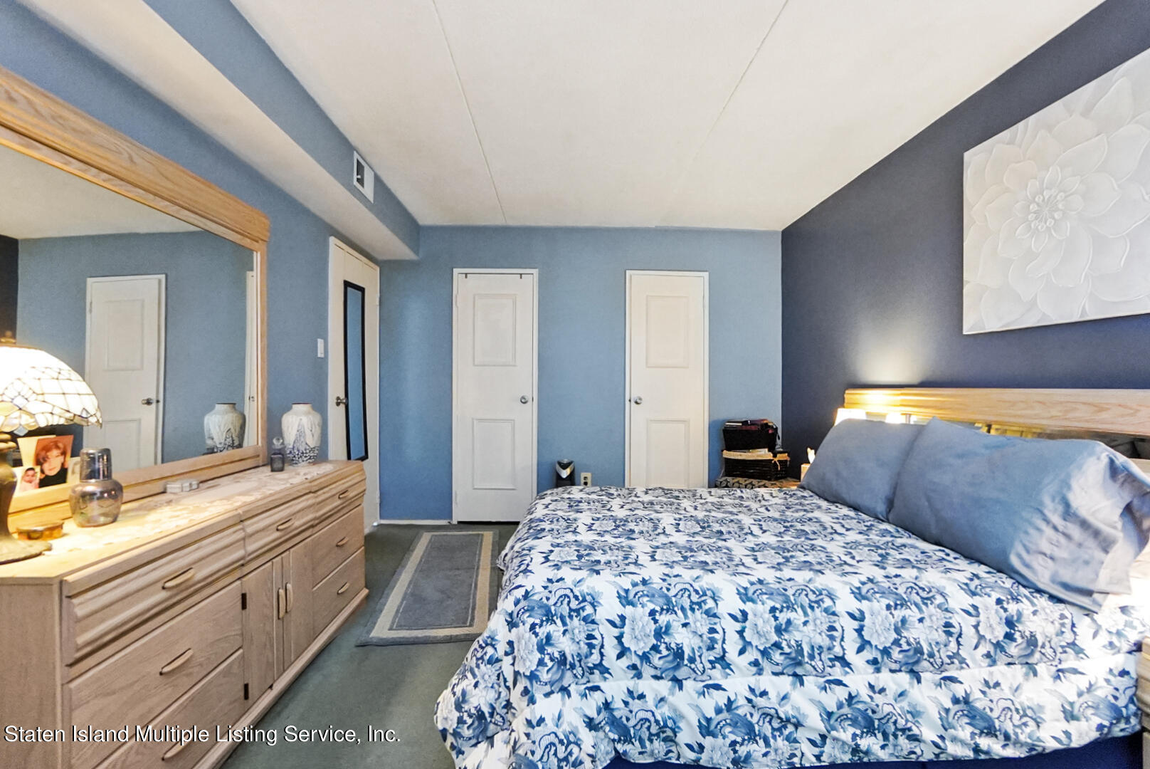 10 Windham Loop, Unit 1A Staten Island, NY 10314 - Photo 16 of 19 a bedroom with a large bed and a dresser