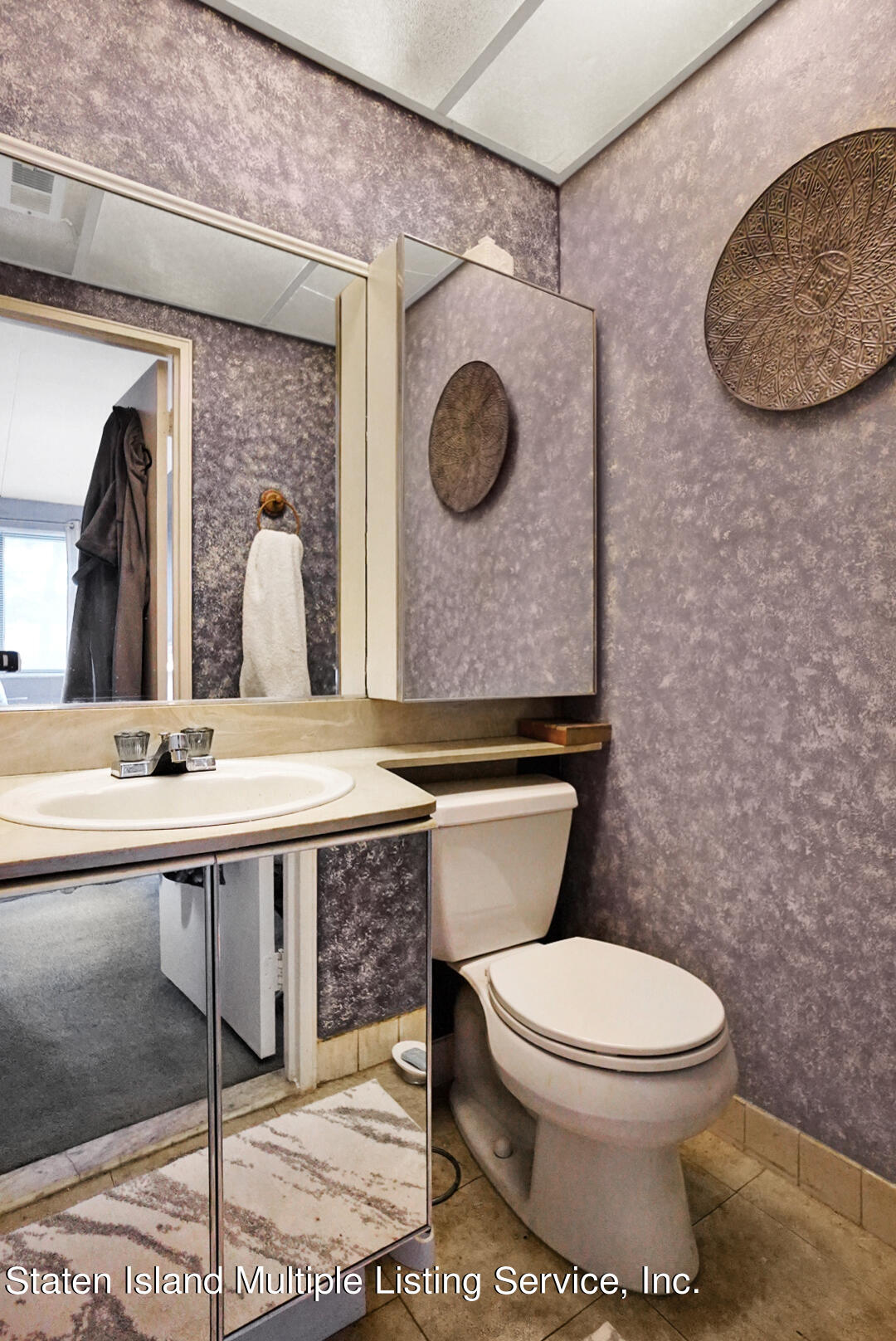 10 Windham Loop, Unit 1A Staten Island, NY 10314 - Photo 17 of 19 a bathroom with a toilet a sink and mirror