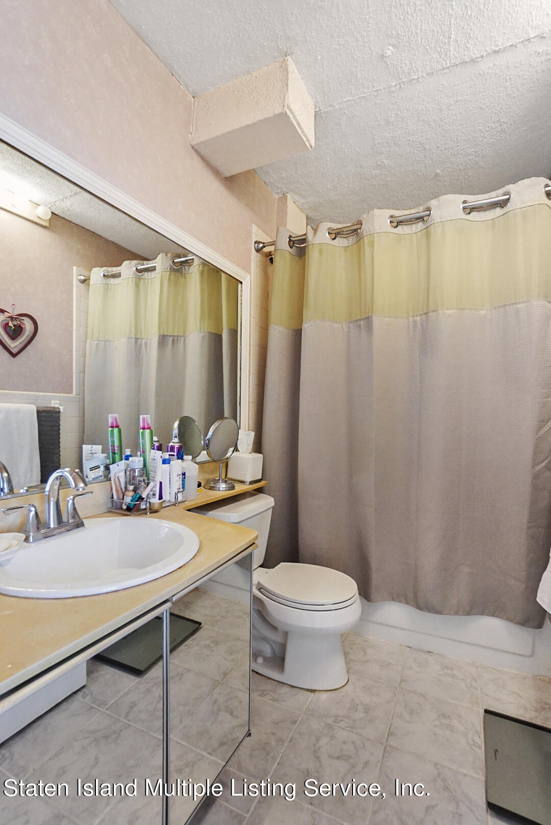 10 Windham Loop, Unit 1A Staten Island, NY 10314 - Photo 19 of 19 a bathroom with a sink toilet and shower