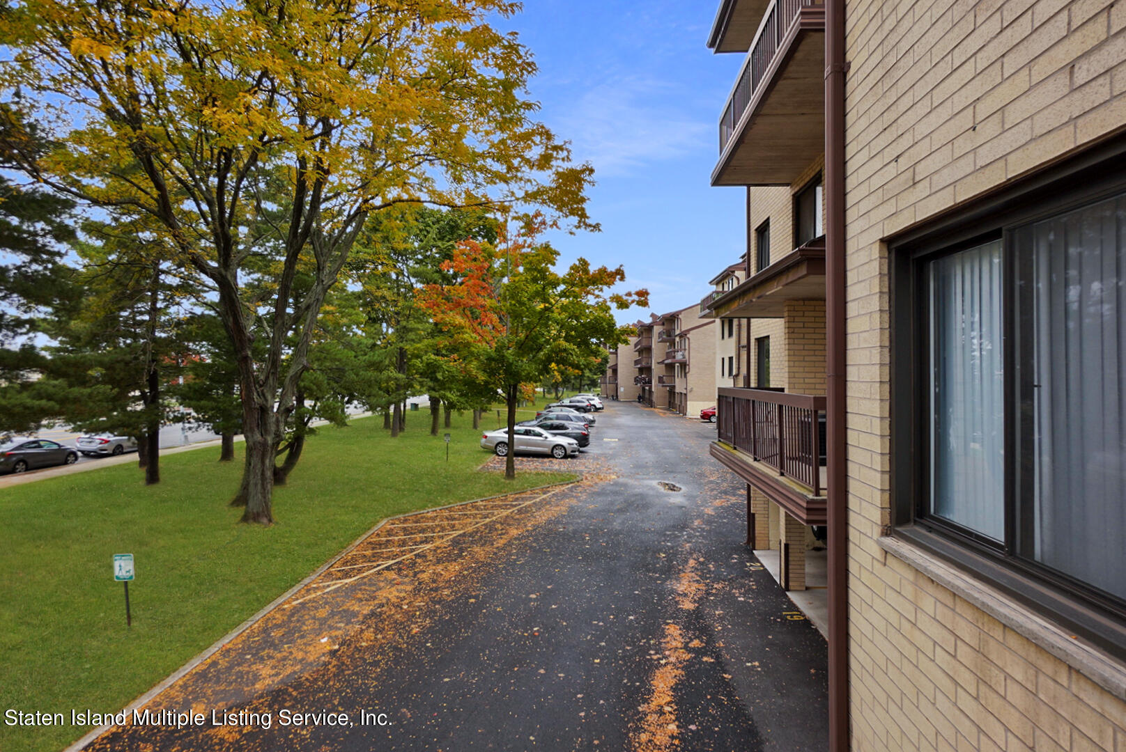 10 Windham Loop, Unit 1A Staten Island, NY 10314 - Photo 3 of 19 a view of a street with a building and a street sign