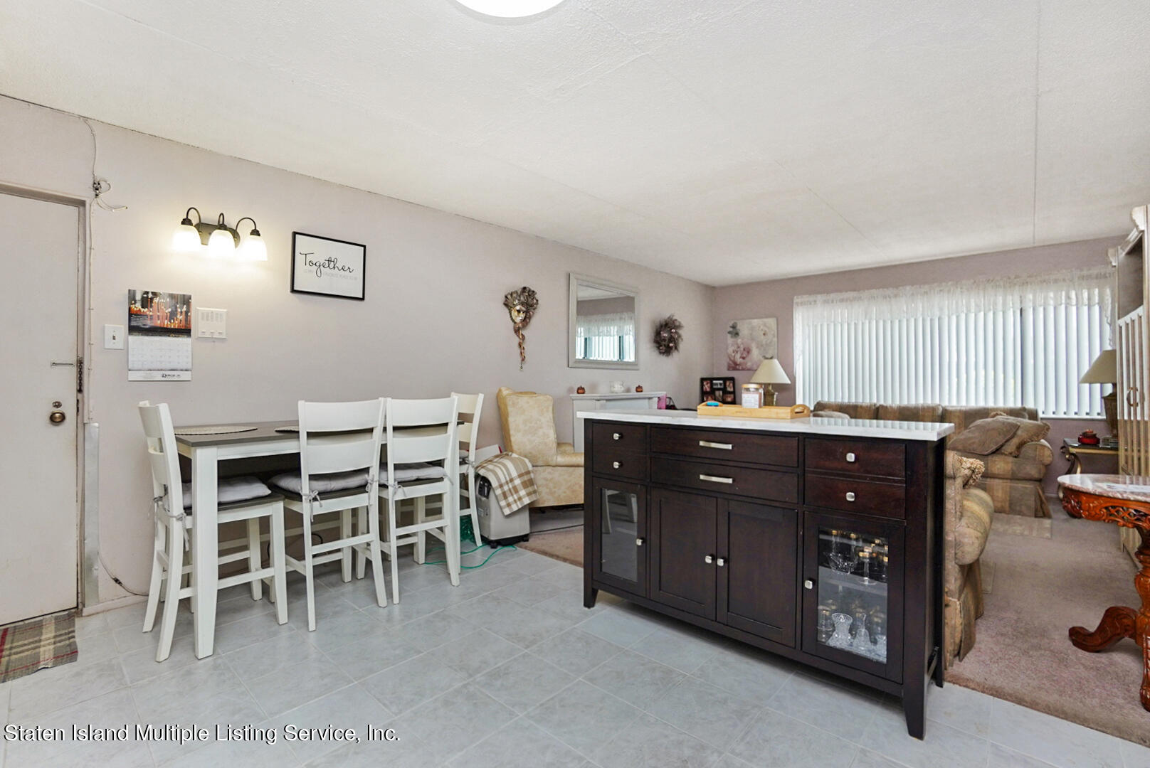 10 Windham Loop, Unit 1A Staten Island, NY 10314 - Photo 6 of 19 a living room with furniture a dining table and a window