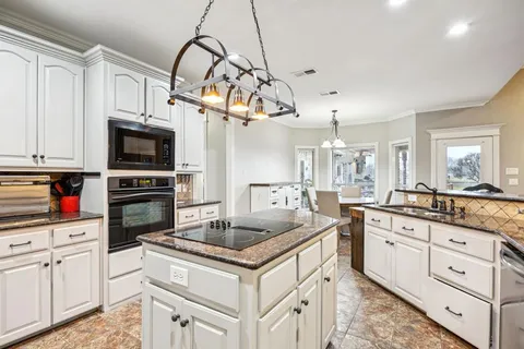 a view of a dining room with furniture large windows and wooden floor