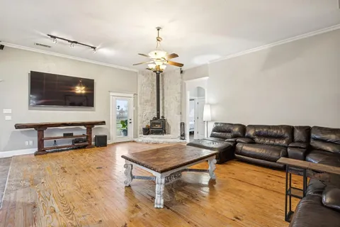 a living room with furniture and a ceiling fan
