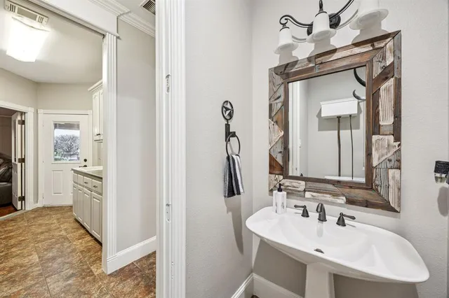 a kitchen with granite countertop white cabinets and sink